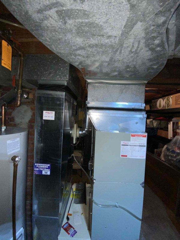Conducted assessment of 21-year-old HVAC system in basement, with non-functioning natural gas furnace and operational AC unit. Documented existing equipment configuration including ductwork connections and current installation conditions. Prepared replacement estimate for new furnace and air conditioning system per BOGO promotion.