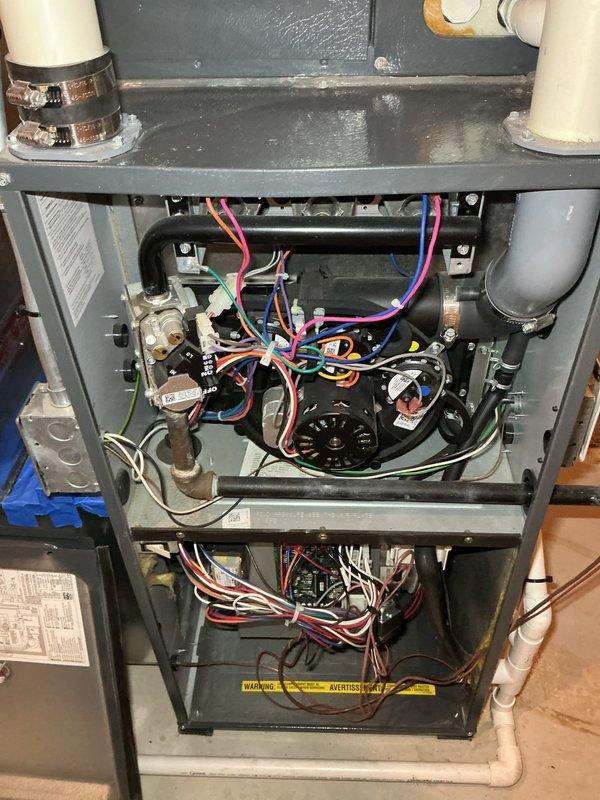 Performed annual heating maintenance service on HVAC system. Inspected interior components including blower motor, electrical connections, and control boards. Noted some moisture/condensation on upper metal tray surface that will require monitoring. Customer advised that replacement filters are needed.