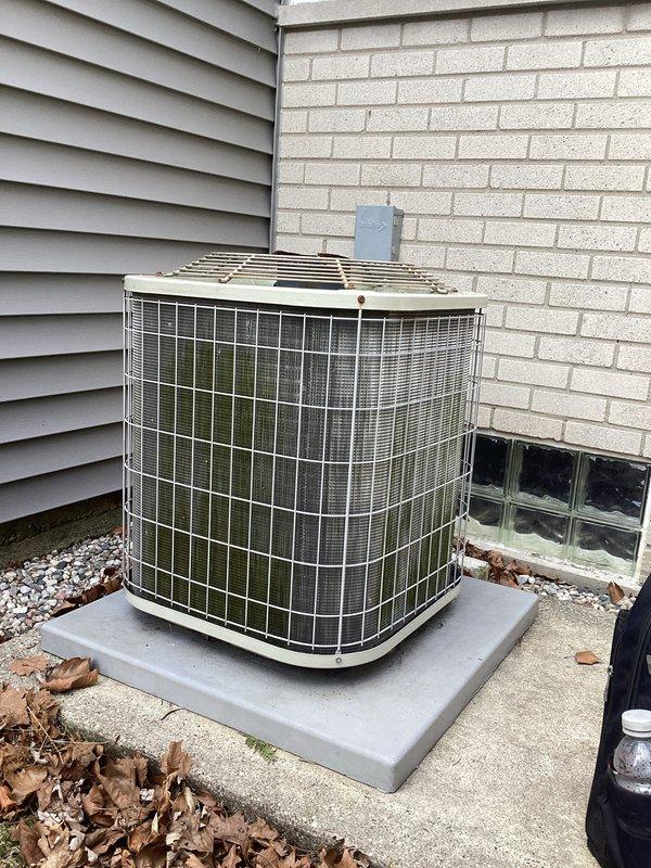 Performed scheduled maintenance on Emerson thermostat and outdoor AC condenser unit. System was inspected for proper operation with thermostat reading 68°F and functioning correctly. Exterior condenser unit was examined, showing no visible damage or unusual wear, with proper installation on concrete pad and adequate drainage bed.