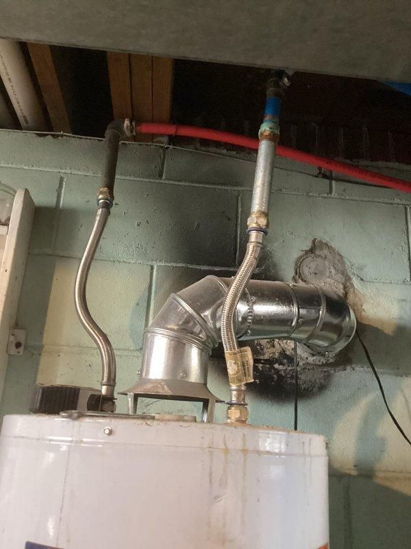 Responded to service call for a flooded basement and no hot water in residence. Diagnosed issue with Envirotempr water heater; pilot light was extinguished following water intrusion. Successfully relit pilot light, verified proper ventilation connections, and confirmed system returned to normal operation with hot water restored throughout the home.