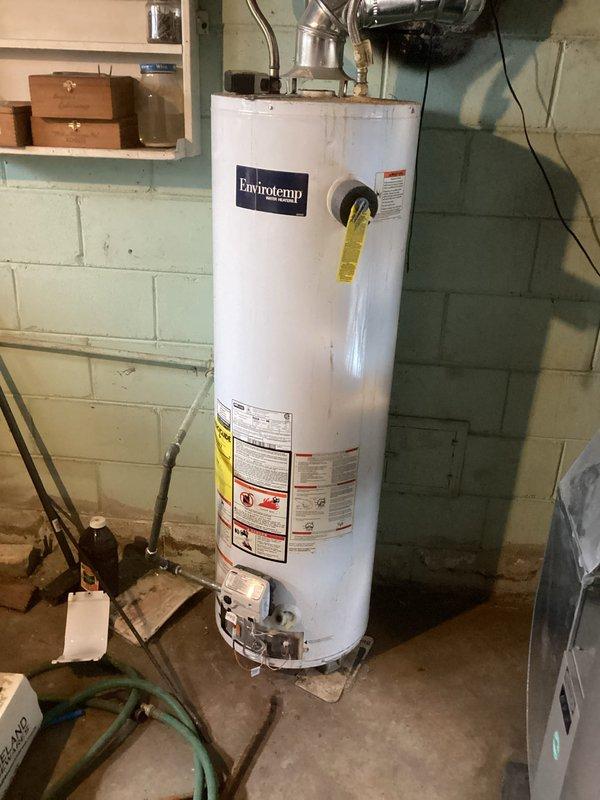 Responded to service call for a flooded basement and no hot water in residence. Diagnosed issue with Envirotempr water heater; pilot light was extinguished following water intrusion. Successfully relit pilot light, verified proper ventilation connections, and confirmed system returned to normal operation with hot water restored throughout the home.