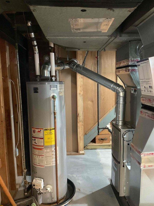 Completed installation of a complete HVAC system including a 70,000 BTU furnace and 2-ton air conditioning unit with all necessary mechanical and electrical connections. System was properly mounted in the utility area with appropriate ductwork modifications and reconnections, and all required mechanical and electrical permits were secured prior to installation.