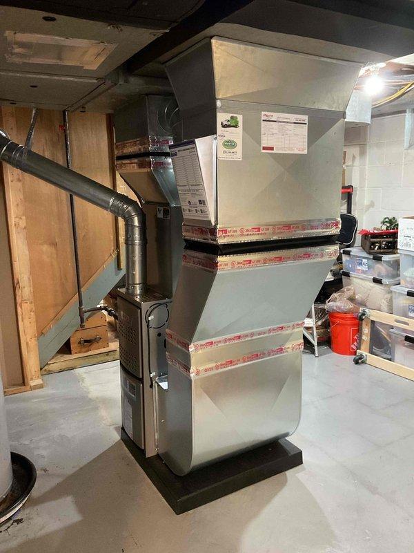 Completed installation of a complete HVAC system including a 70,000 BTU furnace and 2-ton air conditioning unit with all necessary mechanical and electrical connections. System was properly mounted in the utility area with appropriate ductwork modifications and reconnections, and all required mechanical and electrical permits were secured prior to installation.