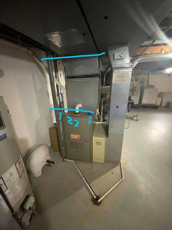 Conducted comprehensive site evaluation for potential mini split installation in residential property. Assessed basement mechanical room containing existing furnace system with connected ductwork and examined underside of basement ceiling structure with exposed wooden joists and existing rectangular HVAC ductwork. Customer seeking new mini split system with no pre-existing equipment.