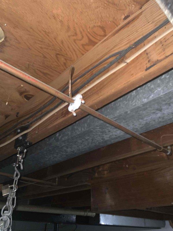 Conducted comprehensive site evaluation for potential mini split installation in residential property. Assessed basement mechanical room containing existing furnace system with connected ductwork and examined underside of basement ceiling structure with exposed wooden joists and existing rectangular HVAC ductwork. Customer seeking new mini split system with no pre-existing equipment.