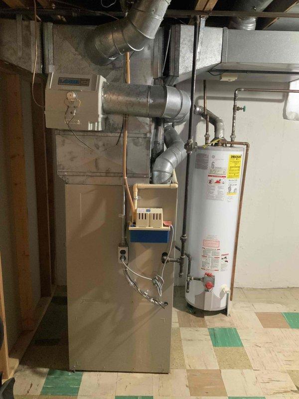 Conducted comprehensive assessment of 37-year-old forced air HVAC system for potential replacement with Lennox high efficiency furnace (single stage, constant velocity blower) with humidifier and lower SEER A/C unit. Inspected current furnace venting through chimney and determined water heater will require chimney liner. Noted installation requirements including new line set and condenser disconnect for the 980 sq ft ranch home with uninsulated exterior walls.