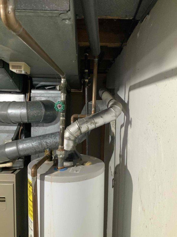 Conducted comprehensive assessment of 37-year-old forced air HVAC system for potential replacement with Lennox high efficiency furnace (single stage, constant velocity blower) with humidifier and lower SEER A/C unit. Inspected current furnace venting through chimney and determined water heater will require chimney liner. Noted installation requirements including new line set and condenser disconnect for the 980 sq ft ranch home with uninsulated exterior walls.