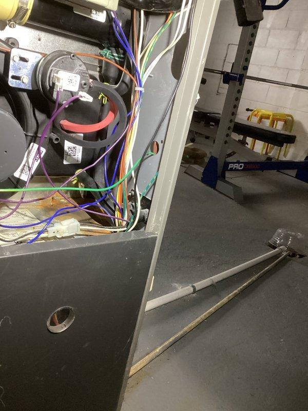 Responded to no-heat complaint on 12-year-old forced air furnace system. Diagnostic inspection revealed faulty electrical components with corrosion at condensate drain connection point. Replaced damaged wiring harness and motor components, cleaned corroded connections, and verified proper system operation before completing service.