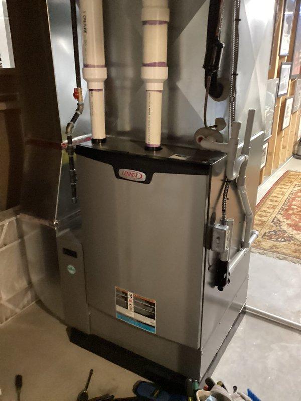 Performed scheduled Air Care Heating and Cooling maintenance on Lennox furnace system. Inspected internal components including blower motor assembly, electrical connections, and control board - all found in normal working condition with no visible damage. Examined and verified proper function of exhaust/intake venting system with appropriate PVC piping.