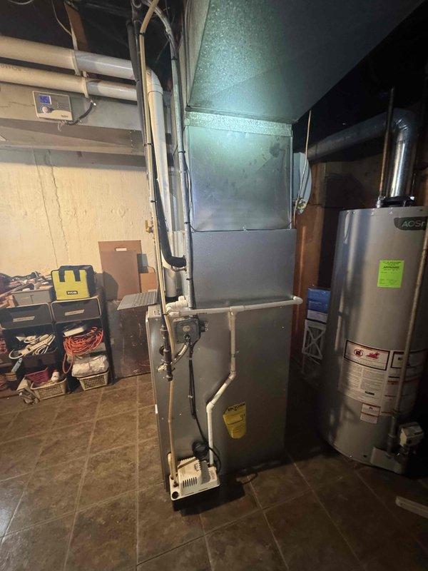 Conducted full system evaluation of 16-year-old AC unit in residential mechanical room. Inspected existing furnace, ductwork, and condensate lines for potential replacement. Documented equipment condition with photographs, noting age of system and current configuration in preparation for imminent full system replacement quote.