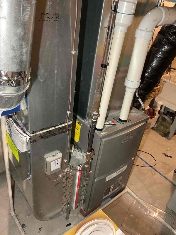 Conducted assessment of non-operational water heater replacement needs. Inspected existing HVAC system configuration, including furnace unit with PVC ventilation pipes, associated ductwork, and plumbing connections. Customer unavailable until 4:15; determination of vent type (power vent vs. natural draft) pending further inspection.