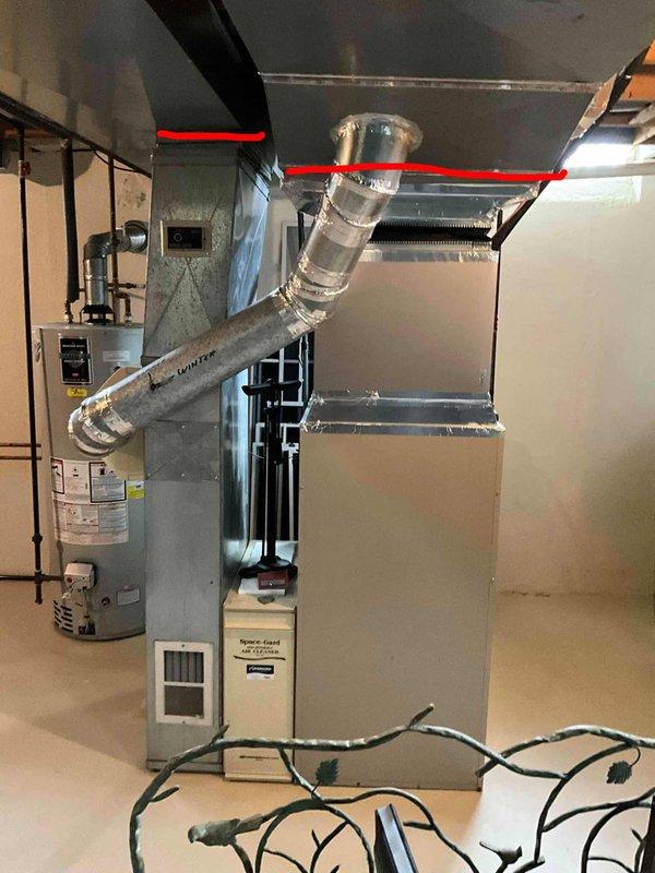 Performed estimate for replacement of 32-year-old gas furnace system showing signs of leakage. Current installation includes aging Falco-branded furnace with Y-shaped ductwork configuration and connected humidifier, all located in basement. Unit is operational but requires replacement due to age and water leakage issues.