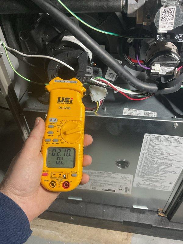 Performed annual furnace maintenance with comprehensive electrical testing using UEi DL379B clamp meter, measuring voltage and current values across system components. Inspected gas valve connections and control module functionality, confirming proper operation with readings of 82.10 on primary circuits. All components functioning within manufacturer specifications; system is ready for the upcoming heating season.