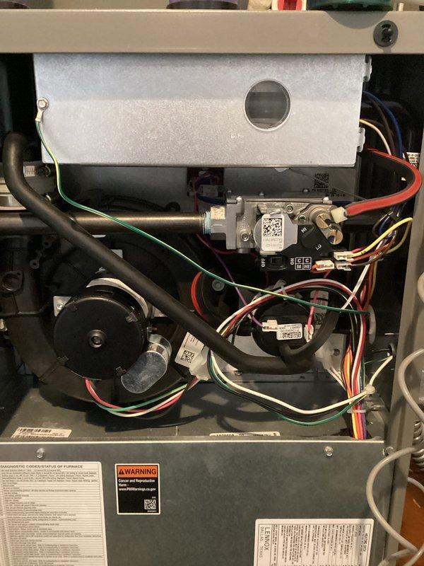 Performed diagnostic inspection and tune-up on 2-year-old Lennox WT 10-2033 system that was reported non-operational with humidifier leakage. Opened access panels to examine internal components including blower assembly, circuit boards, and electrical connections. Identified and resolved moisture issue from humidifier affecting unit operation and completed standard maintenance procedures on both air handler and furnace systems to restore proper functionality.