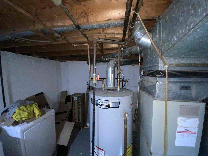 Conducted evaluation of 1998 natural gas furnace system located in basement. Unit is currently operational but approaching end of useful life at 25+ years. Inspection revealed aging ductwork with multiple connection points and a Honeywell humidifier component integrated into the system. Replacement options were presented to upgrade efficiency and reliability while utilizing existing utility connections.