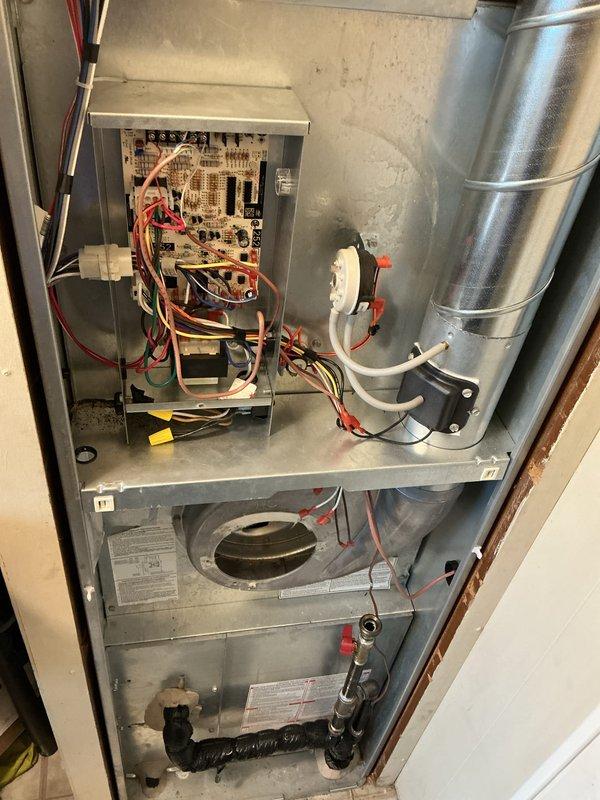 Performed routine air handler maintenance service on residential HVAC system. Accessed and inspected control board, electrical connections, and blower assembly, ensuring all components were functioning properly. Documented system condition with photos showing interior components including circuit board, wiring, and blower housing for service records.