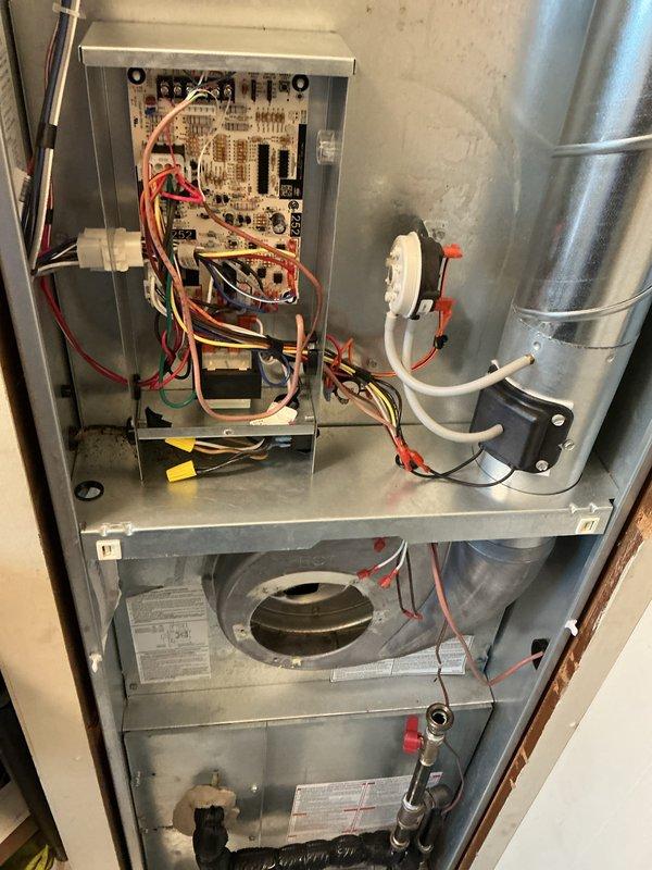 Performed routine air handler maintenance service on residential HVAC system. Accessed and inspected control board, electrical connections, and blower assembly, ensuring all components were functioning properly. Documented system condition with photos showing interior components including circuit board, wiring, and blower housing for service records.