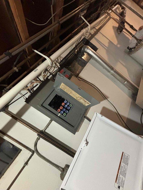 Conducted comprehensive assessment of electrical system in preparation for potential furnace replacement. Inspected existing electrical panel to evaluate capacity for supporting new HVAC equipment, noting current 80k BTU Carrier unit requiring replacement in 1400sf home. Documented electrical infrastructure with photos to ensure proper planning for future installation.