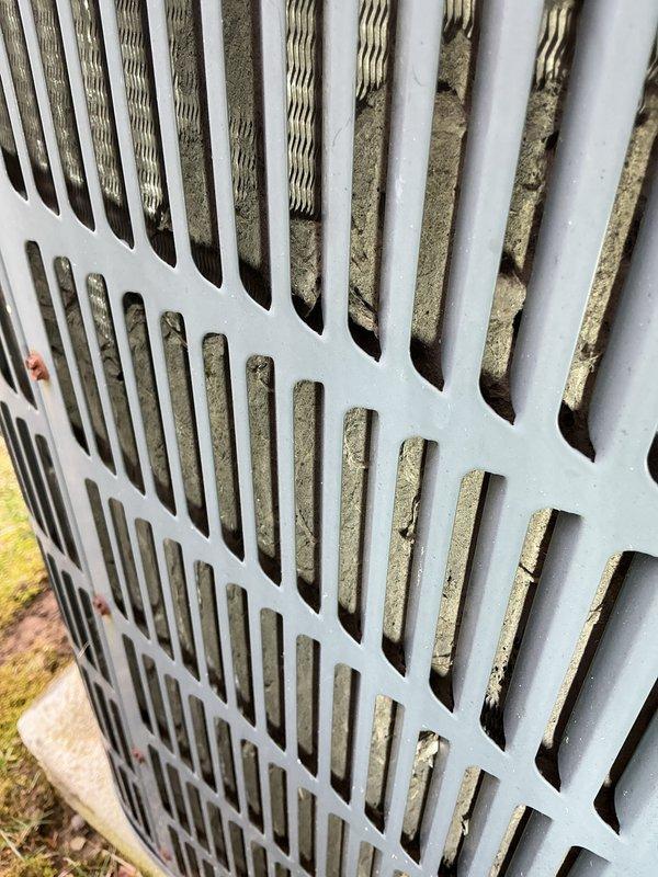 Performed routine maintenance on 20-year-old AC system that was still operational. Inspected outdoor condenser unit and identified significant dust/debris accumulation on coils and heat exchange components requiring cleaning. System was serviced according to manufacturer specifications to maintain optimal cooling performance.