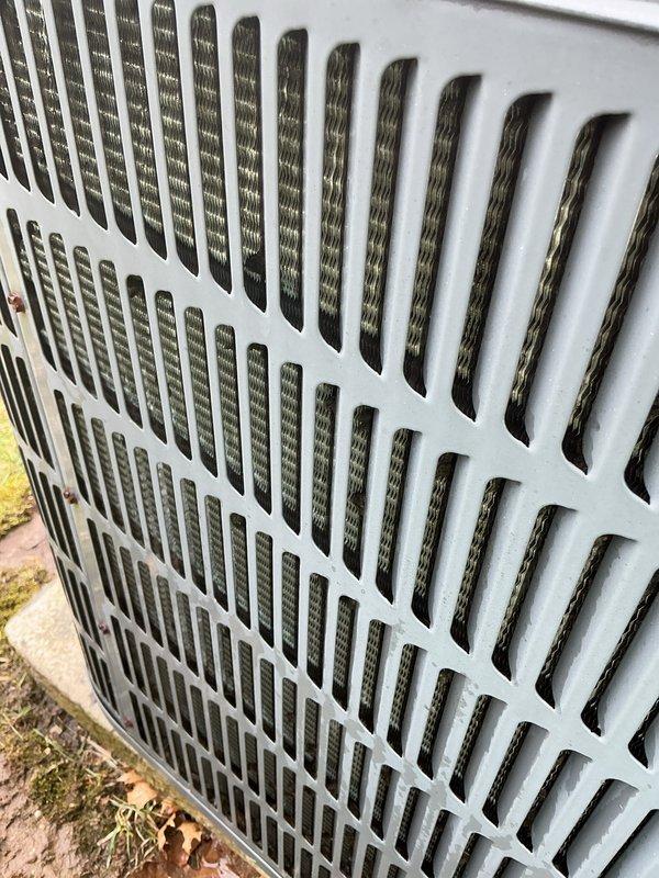 Performed routine maintenance on 20-year-old AC system that was still operational. Inspected outdoor condenser unit and identified significant dust/debris accumulation on coils and heat exchange components requiring cleaning. System was serviced according to manufacturer specifications to maintain optimal cooling performance.