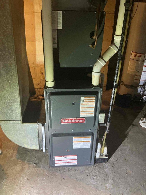 Performed annual maintenance on a Goodman furnace system. Completed comprehensive tune-up including inspection of ventilation pipes, connections, and overall unit condition. System is functioning properly with no issues identified; unit is well-installed with appropriate PVC ventilation in basement utility area.