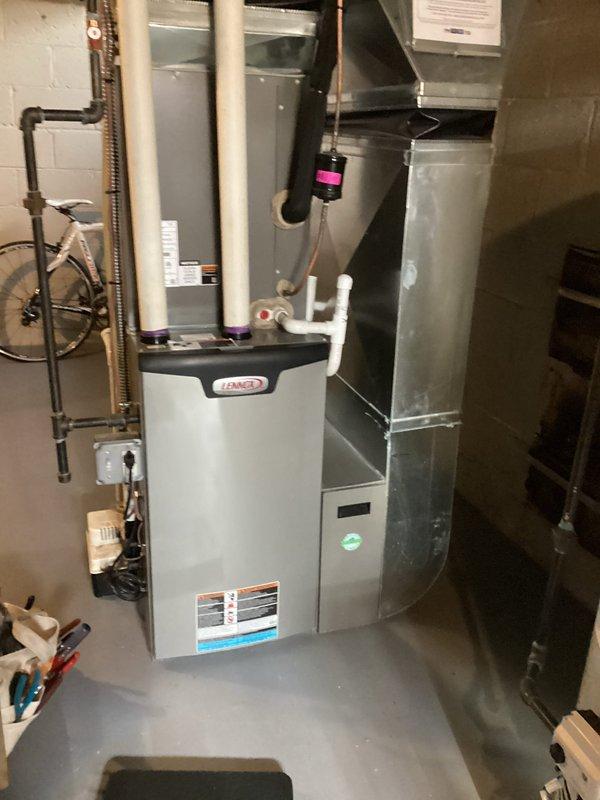 Performed annual maintenance on Lennox furnace system located in basement. Completed comprehensive tune-up including inspection of all connections, PVC exhaust/intake pipes, and condensate drain line. System is functioning properly with no issues identified; unit is well-maintained and all components are in good working condition.