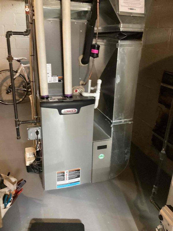 Performed annual maintenance on Lennox furnace system located in basement. Completed comprehensive tune-up including inspection of all connections, PVC exhaust/intake pipes, and condensate drain line. System is functioning properly with no issues identified; unit is well-maintained and all components are in good working condition.