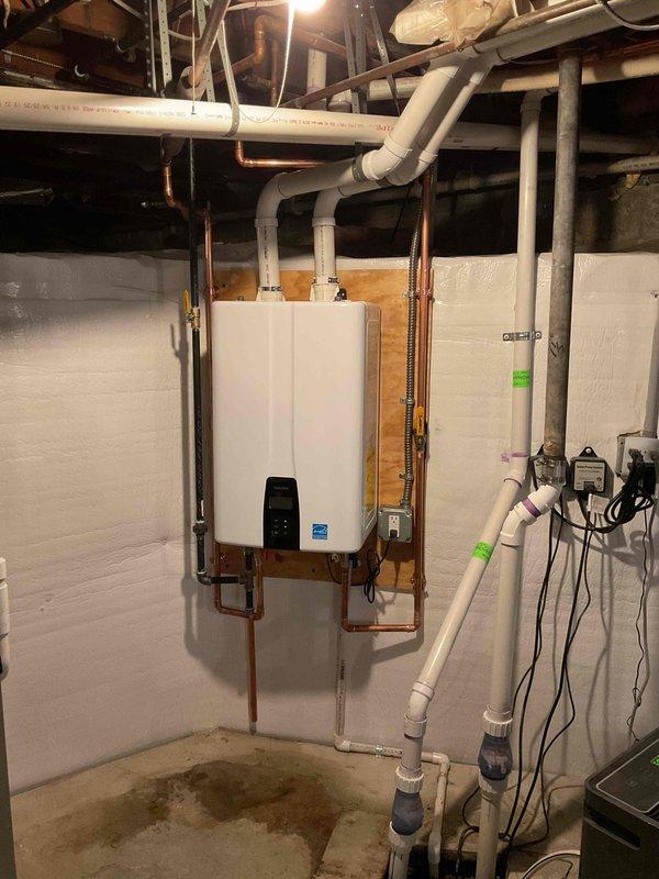 Successfully installed an Energy Star certified tankless water heater with proper copper supply lines and PVC venting. Completed all necessary plumbing connections including condensate drain line with P-trap configuration on exterior wall, and ensured proper electrical reconnection. System was tested and verified operational with all required mechanical permits secured prior to installation.