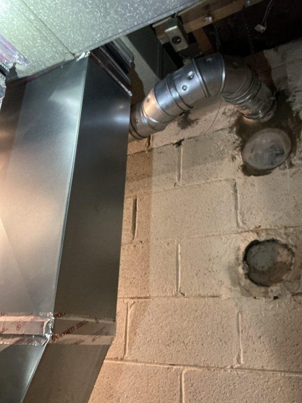 Successfully completed furnace installation in basement utility area, installing new unit with proper ductwork connections against concrete block wall. System was fully mounted with sealed joints, electrical components properly connected, and all necessary permits were requested.