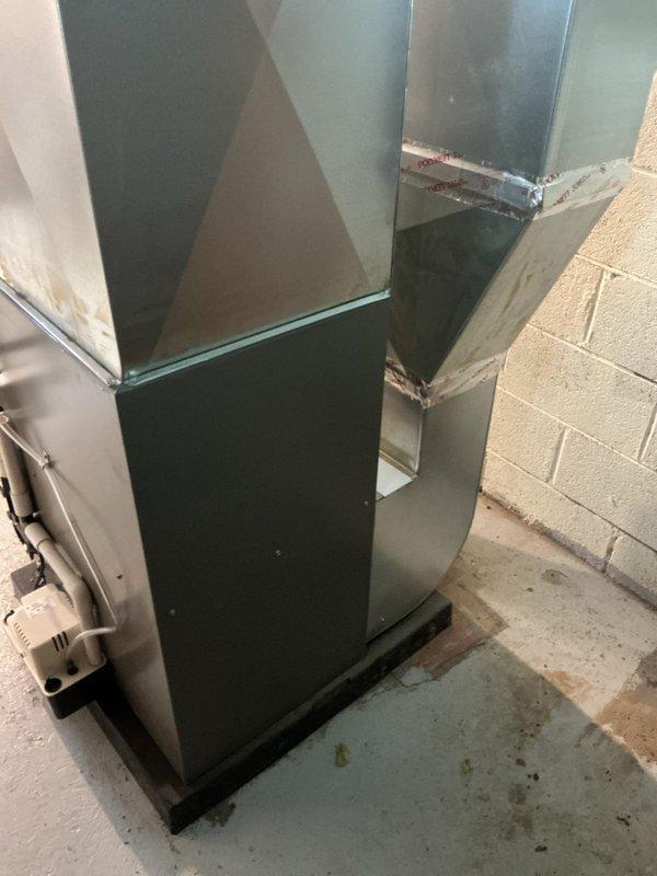 Successfully completed furnace installation in basement utility area, installing new unit with proper ductwork connections against concrete block wall. System was fully mounted with sealed joints, electrical components properly connected, and all necessary permits were requested.