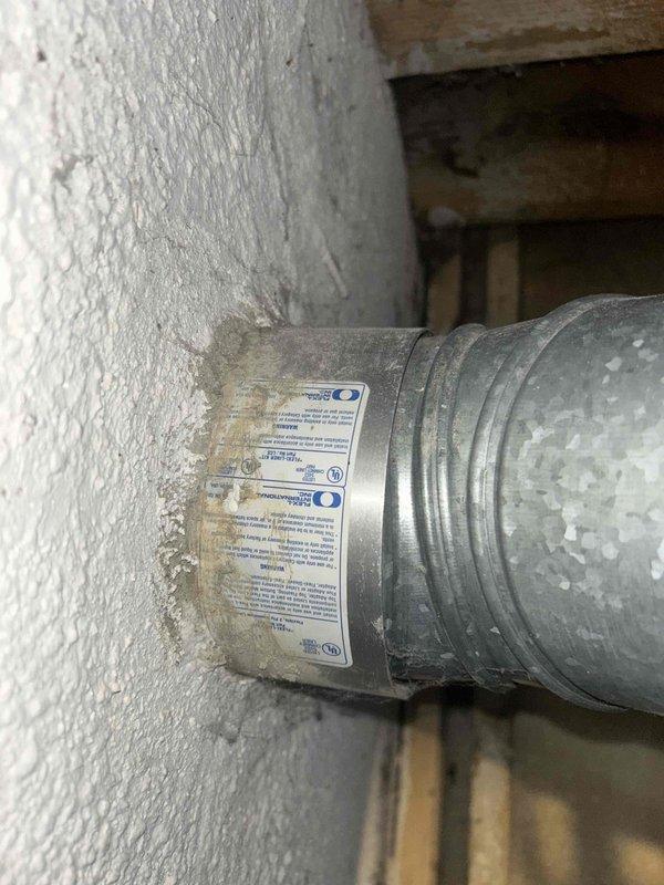 Conducted assessment of non-operational 15-year-old gas furnace and AC system located in basement. Inspection revealed aging ductwork with visible manufacturer labels and deterioration. Photographed existing installation including furnace, water heater, humidifier attachment, and galvanized sheet metal ductwork configuration for replacement quote preparation.
