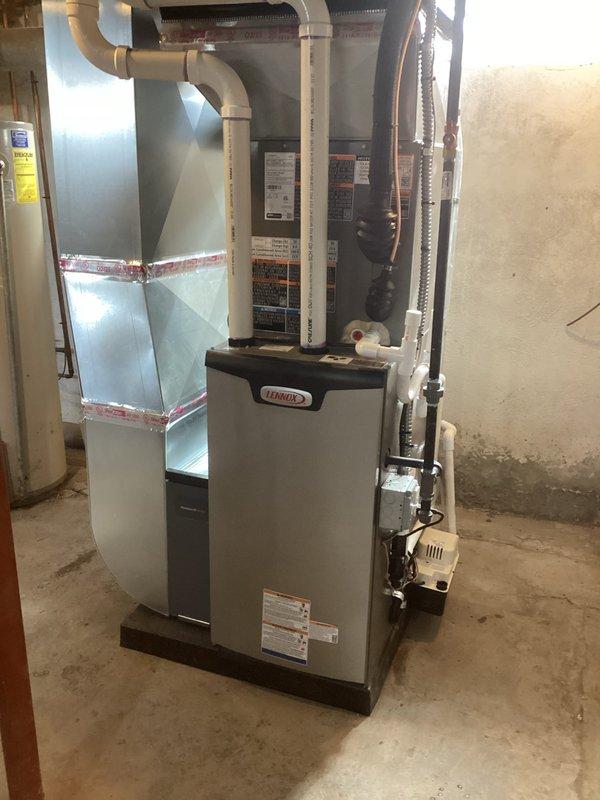 Successfully installed a complete HVAC system including a new Lennox furnace (70,000 BTU) and 2-ton air conditioning unit. Work included installation of proper PVC venting, ductwork connections sealed with metallic tape, and addition of a humidifier. Removed existing chimney liner and reconnected all necessary electrical and plumbing components to ensure full system functionality.