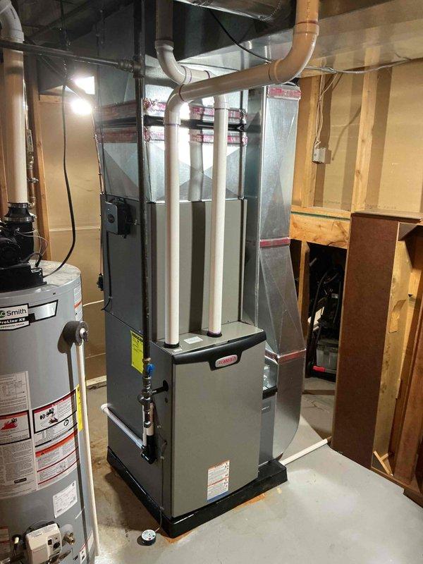 Successfully installed a complete HVAC system including a 90K BTU furnace and 3-ton Lennox air conditioning unit. The installation involved proper positioning of the outdoor condenser unit adjacent to the foundation wall with appropriate electrical conduit and refrigerant line connections, while the indoor furnace was installed in the basement mechanical room with PVC exhaust venting and proper ductwork integration.