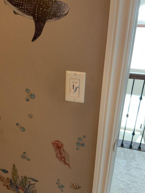 Responded to service call for multiple electrical issues. Replaced malfunctioning bathroom fan control switch labeled "Fan Light" in children's room, featuring slider controls. Also serviced ceiling-mounted bathroom exhaust fan with square cover and horizontal ventilation slats, ensuring proper functionality. Diagnosed breaker panel issue and completed necessary repairs to restore system reliability.