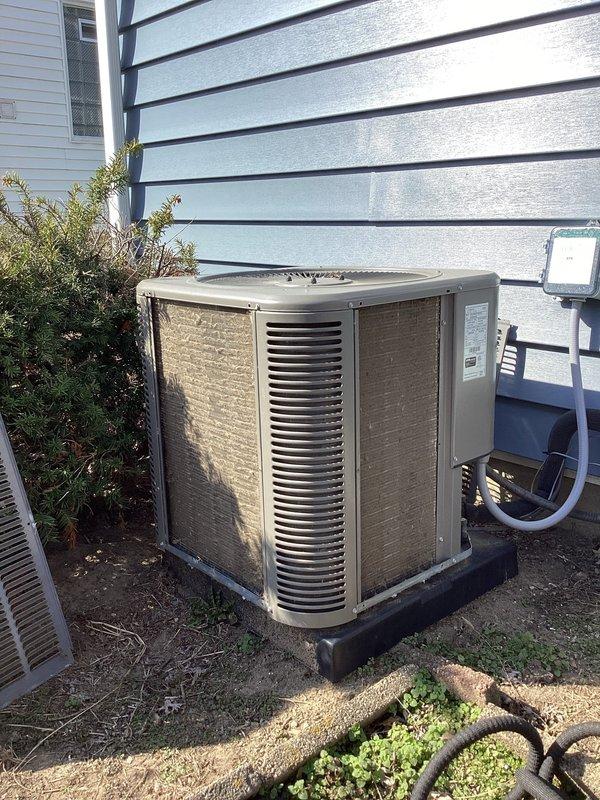 Performed scheduled ComfortGuard Maintenance service on residential AC system. Inspected outdoor condenser unit showing normal wear and dirt accumulation; unit is functioning properly and mounted securely on appropriate pad. Checked electrical connections and refrigerant lines; all components in working order with no immediate concerns identified.