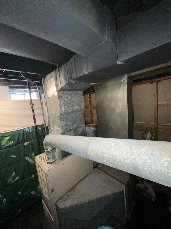 Performed assessment of non-functioning 30+ year old HVAC system in basement. Inspection revealed aging furnace with deteriorated ventilation components and outdated ductwork showing significant dust accumulation and wear. Recommended complete replacement of furnace and AC unit under current BOGO promotion to restore proper heating and cooling functionality.