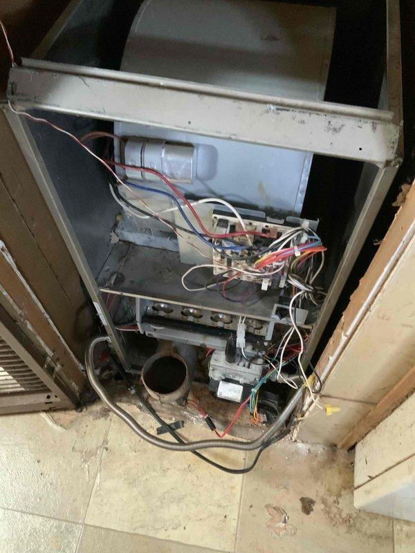 Conducted assessment of a non-functioning 15-year-old gas furnace located in the utility room. Inspection revealed significant internal component deterioration, disorganized wiring, and corrosion on the heat exchanger. Customer previously attempted installation of a used furnace which failed to operate, necessitating complete system replacement rather than repair.