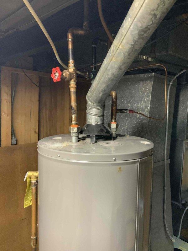 Conducted an HVAC system replacement estimate for a mid-large residence (2000-3000 sq.ft.) with a basement-located natural gas/propane system. Evaluated existing equipment including furnace unit, water heater installation with copper piping connections, and associated ductwork and humidifier components for appropriate replacement specifications.