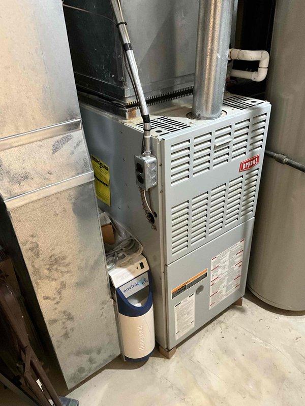 Completed inspection of 23-year-old Bryant gas furnace and AC system in unfinished basement requiring full replacement. System shows significant age-related deterioration with outdated components visible in the mechanical room where furnace is installed alongside Envirotec water treatment system. Customer requires additional plumbing estimate; comprehensive HVAC replacement proposal prepared for both furnace and air conditioning units.