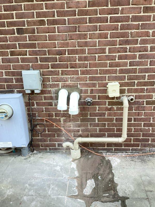 Successfully installed dual tankless water heaters with complete mechanical reconnection of all necessary plumbing components. System features copper supply lines connecting to the wall-mounted units, with proper PVC venting installed overhead according to manufacturer specifications. All electrical connections were properly established and the system was tested for optimal functionality.