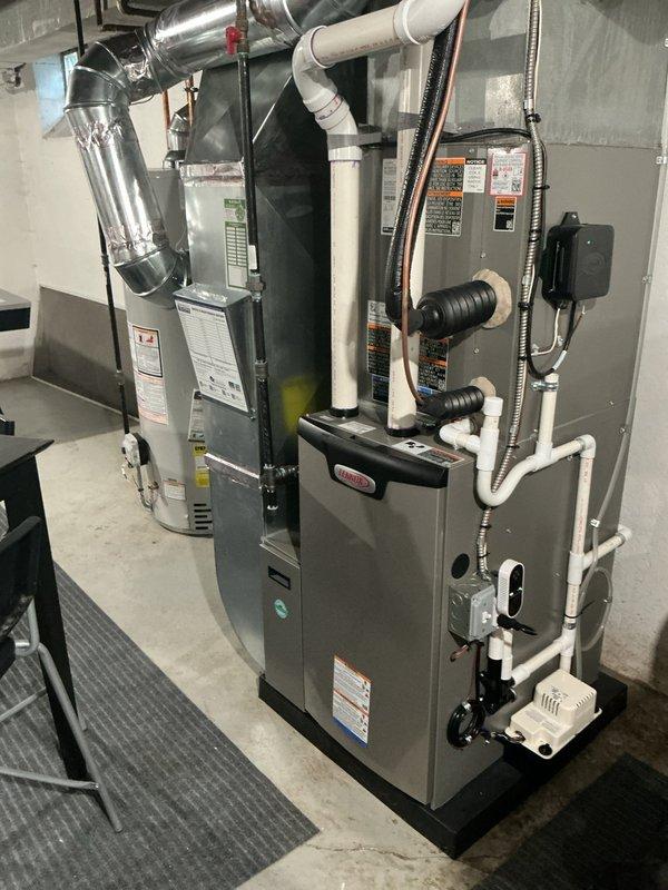 Performed annual heating and cooling maintenance on dual-unit HVAC system located in basement. Inspected furnace, air handler, electrical connections, and drainage systems. All components functioning properly with no issues identified; system is operating at optimal efficiency with clean ductwork and properly connected PVC ventilation pipes.