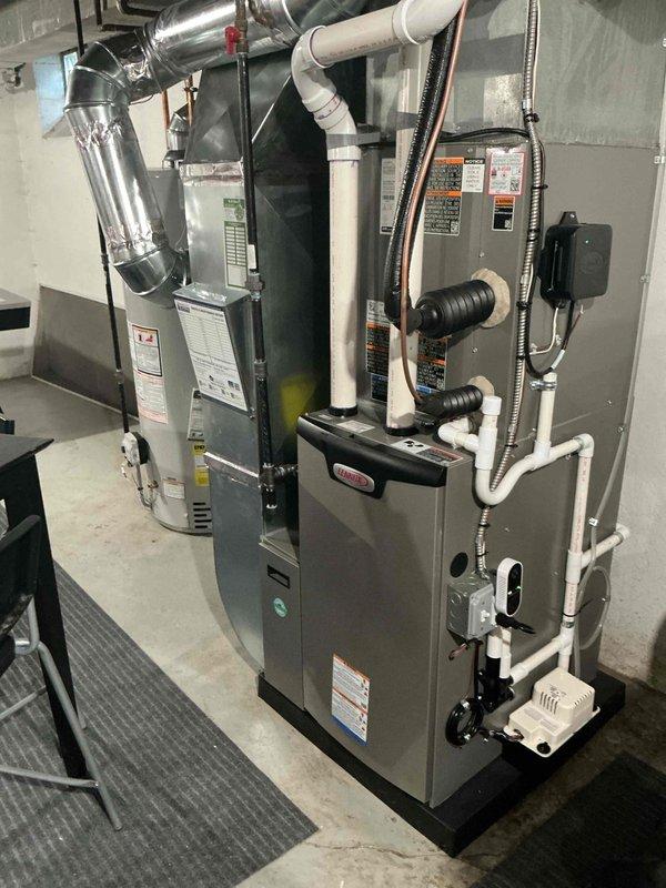 Performed annual heating and cooling maintenance on dual-unit HVAC system located in basement. Inspected furnace, air handler, electrical connections, and drainage systems. All components functioning properly with no issues identified; system is operating at optimal efficiency with clean ductwork and properly connected PVC ventilation pipes.