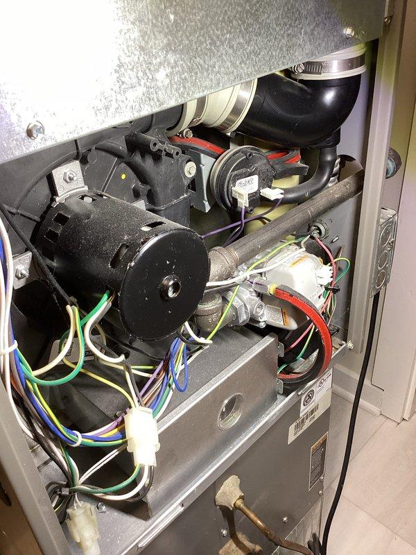 Responded to service call for furnace making thumping noise upon shutdown. Performed diagnostic inspection on 7-year-old unit located at rear of ranch home. Inspected blower assembly, exhaust components, and electrical connections. Checked PVC drainage system and control module functionality. Replaced air filter as requested during annual heating maintenance service. System now operating normally with no unusual shutdown noises.