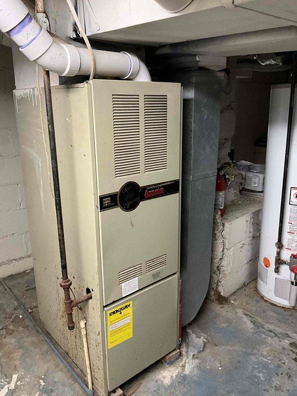 Performed comprehensive evaluation of 20-year-old HVAC system requiring full replacement. Inspected aging furnace with visible deterioration including cabinet discoloration and potential water damage. Documented outdated AC unit and examined existing ductwork configuration to prepare accurate replacement quote for complete system upgrade.