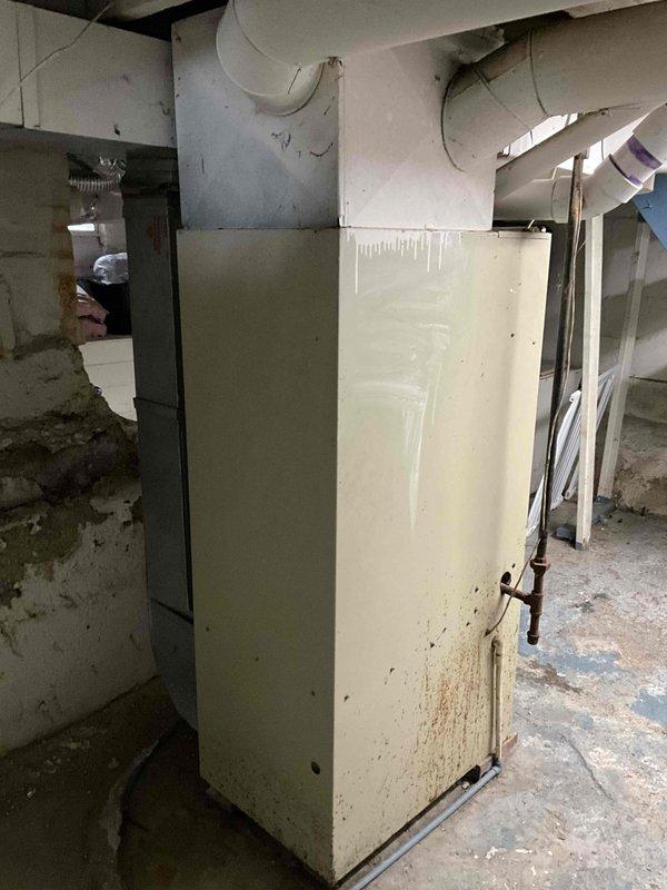 Performed comprehensive evaluation of 20-year-old HVAC system requiring full replacement. Inspected aging furnace with visible deterioration including cabinet discoloration and potential water damage. Documented outdated AC unit and examined existing ductwork configuration to prepare accurate replacement quote for complete system upgrade.