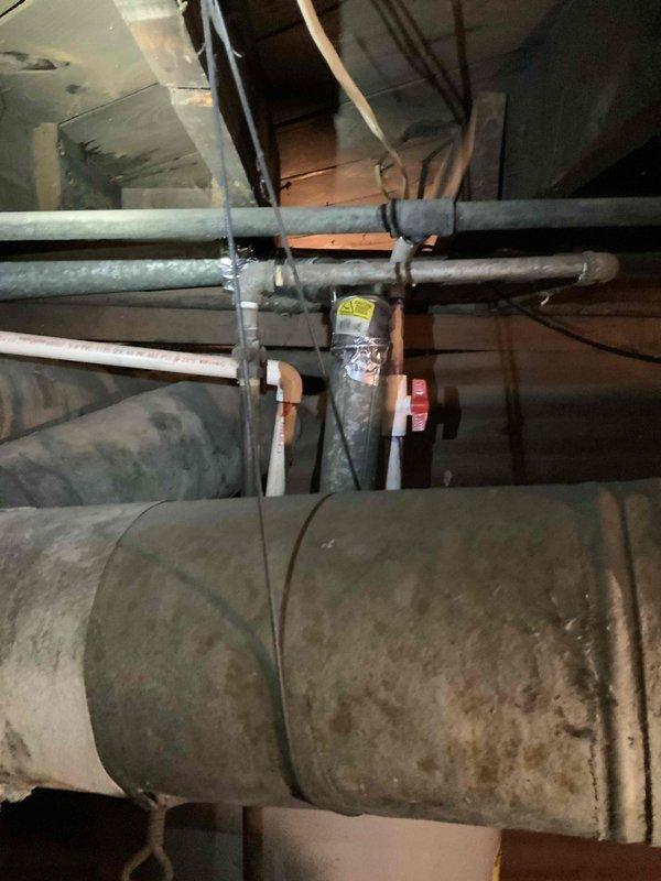 Conducted inspection of aging furnace system in duplex basement that is barely operational. Assessment included examination of existing ductwork, which shows significant wear with dusty metal surfaces and inconsistent insulation on diagonal runs. Evaluation also included adjacent water heater and current ventilation configuration to prepare comprehensive replacement estimate for both furnace and potential AC installation.