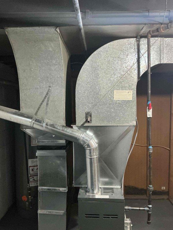 Conducted in-home estimate for customer interested in comparing installation options between traditional central AC and mini-split system for a property with no existing cooling. Inspection revealed an unfinished basement area with exposed ceiling structure and existing ductwork connected to a furnace unit, which could potentially accommodate a traditional central AC system with proper modifications.