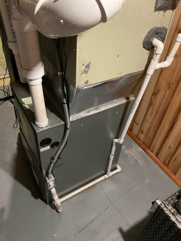 Conducted comprehensive evaluation of 16-year-old residential HVAC system for potential full replacement. Inspected existing furnace showing significant cabinet deterioration and wear on upper section. Examined PVC ventilation system and condensate drainage components, noting current installation configuration for proper replacement specifications. Customer previously received quote for A/C replacement only, but is now requesting complete system estimate for both heating and cooling components.