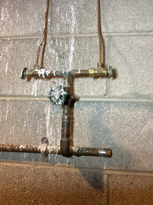 Performed annual furnace maintenance on a functioning system as requested. Inspected plumbing connections, checked valve functionality, and examined electrical wiring for proper connections. Noted minor oxidation on copper pipes with some evidence of previous water damage near the wall mounting but confirmed all components are currently in operational condition.