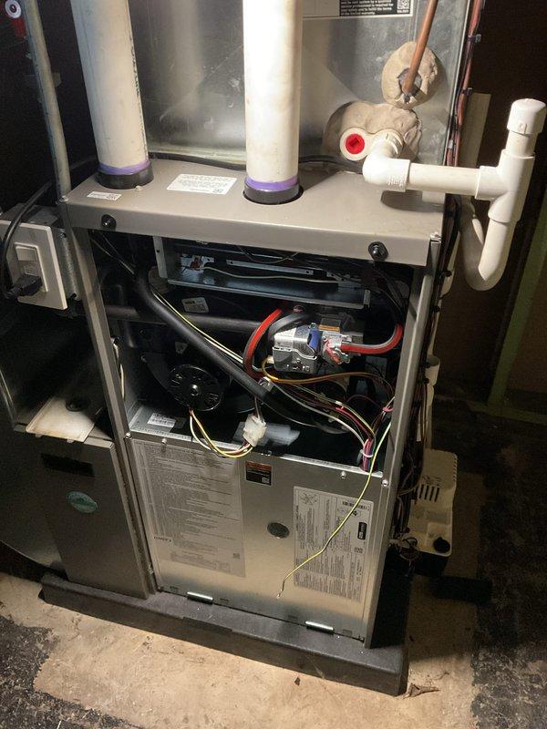 Performed ComfortGuard maintenance package service on HVAC system, which included inspection of outdoor condensing unit showing significant exterior deterioration and internal component exposure. Replaced spots filter and installed new air scrubber as requested, and conducted comprehensive system evaluation with documentation via photos of both outdoor unit and furnace interior components to verify operational status.